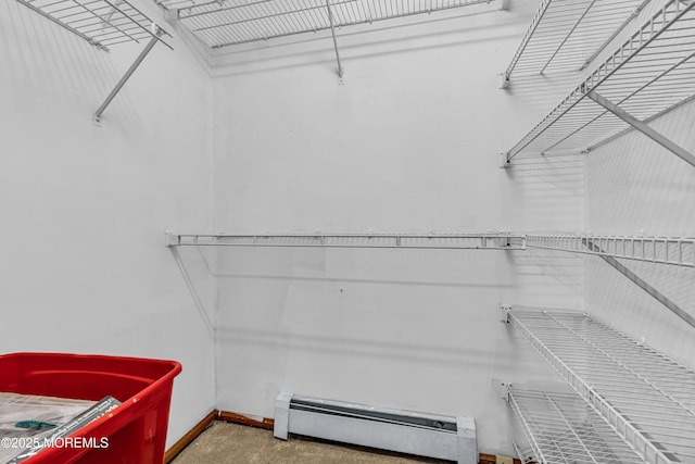 spacious closet with a baseboard heating unit