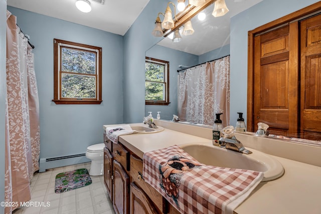 bathroom with toilet, tile patterned floors, a baseboard heating unit, and vanity