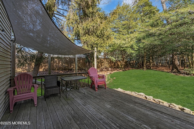 wooden terrace with a lawn