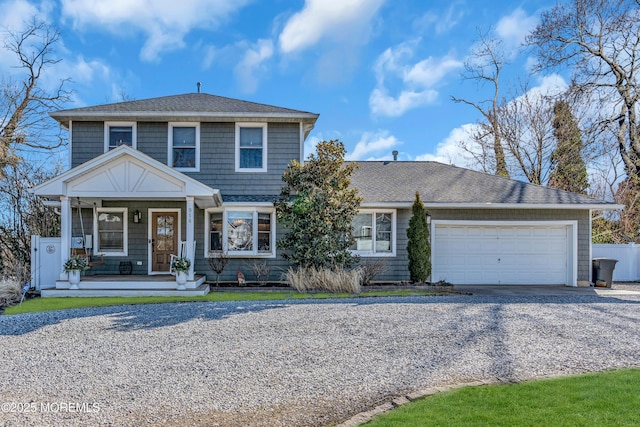 view of front of property featuring a porch, gravel driveway, a shingled roof, and a garage