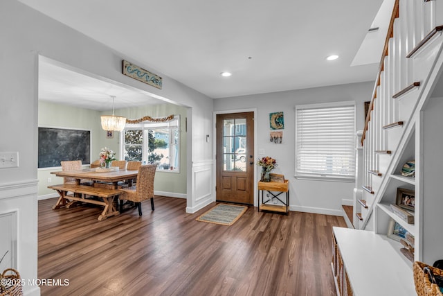 entrance foyer with dark wood-style floors, stairs, and recessed lighting