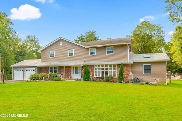 view of front of property with an attached garage, driveway, a front lawn, and brick siding