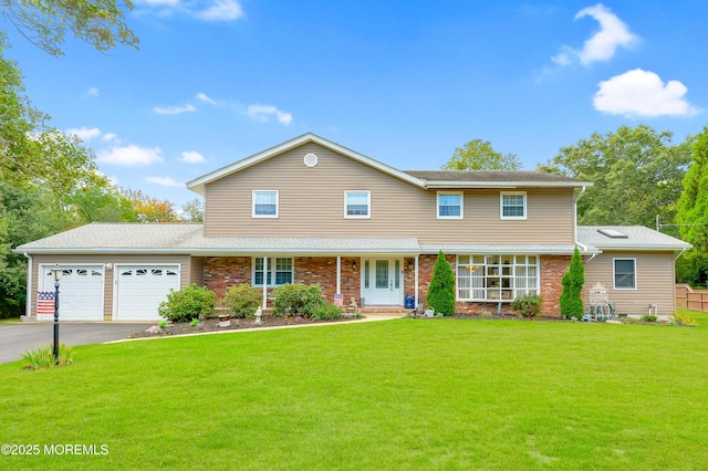 view of front of home featuring a garage, brick siding, driveway, and a front lawn