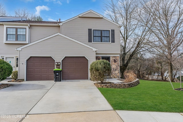 view of front of property featuring a garage, a front yard, concrete driveway, and stone siding