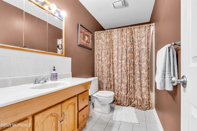 full bathroom with visible vents, toilet, shower / tub combo, vanity, and tile patterned floors