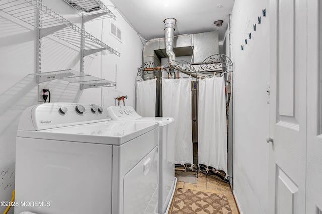 laundry area featuring washing machine and dryer, laundry area, and visible vents