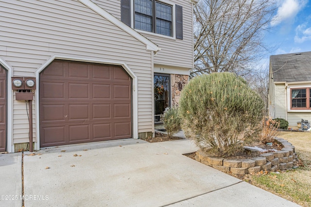 garage featuring concrete driveway