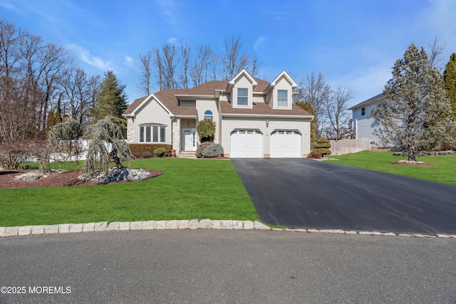 view of front facade with a garage, aphalt driveway, and a front yard