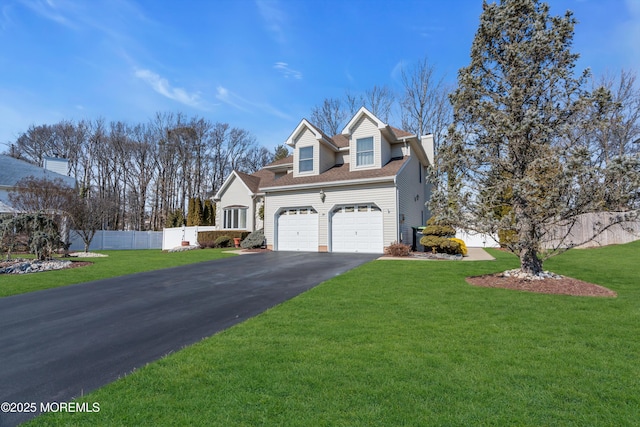 view of front of property with a garage, a front yard, fence, and driveway