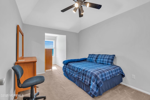 bedroom with lofted ceiling, baseboards, a ceiling fan, and light colored carpet