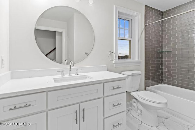 bathroom featuring toilet, marble finish floor, washtub / shower combination, and vanity