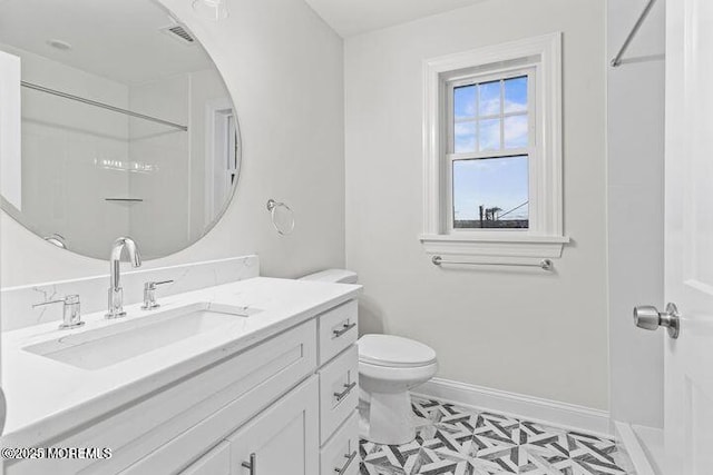 bathroom featuring a shower, visible vents, toilet, vanity, and baseboards