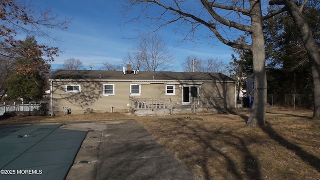 back of property featuring a patio area, fence, and a fenced in pool