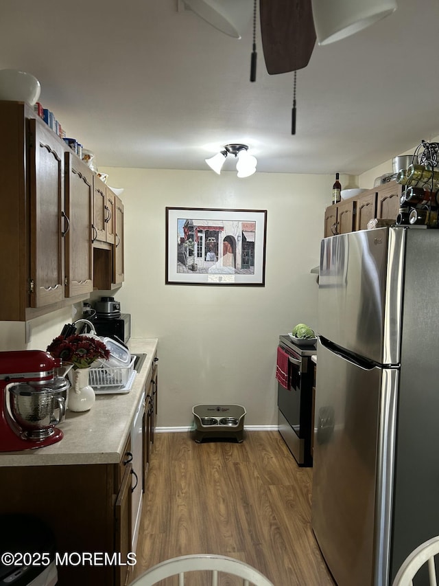 882 Balmoral Ct Unit D, Lakewood, NJ 08701 - kitchen with stainless steel appliances, light countertops, dark wood-type flooring, and baseboards