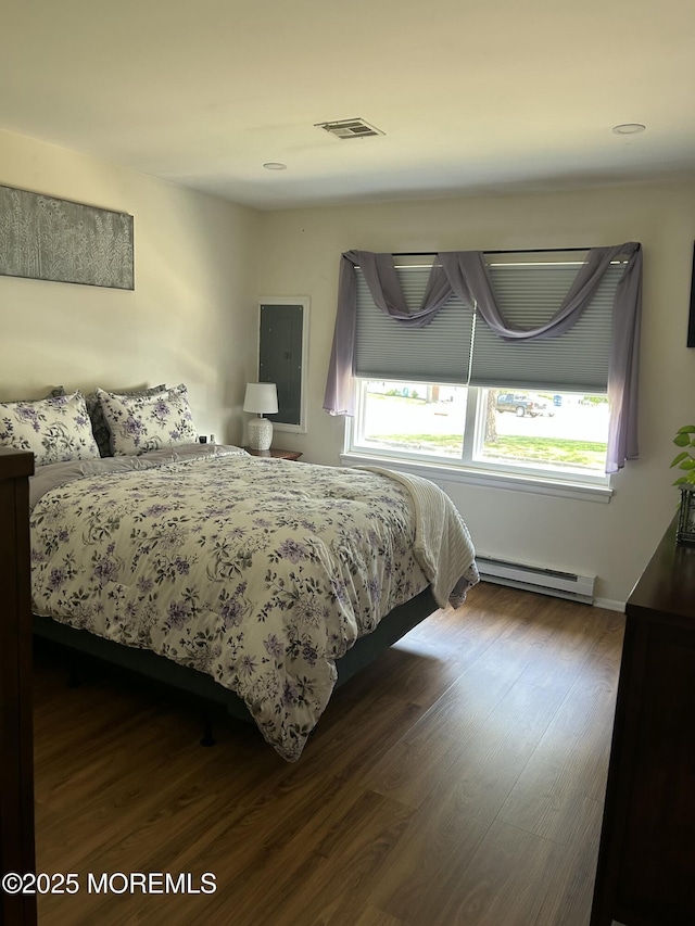 882 Balmoral Ct Unit D, Lakewood, NJ 08701 - bedroom with a baseboard heating unit, dark wood finished floors, and electric panel