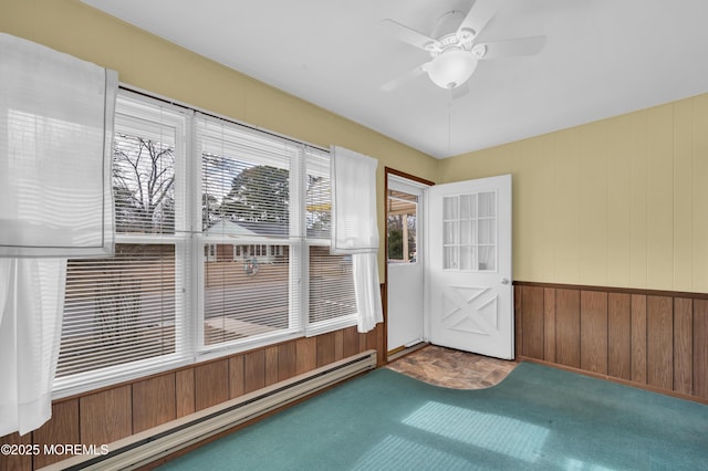 interior space with baseboard heating and a ceiling fan