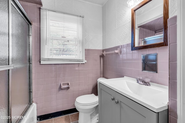 full bathroom with tile patterned flooring, toilet, tile walls, and vanity