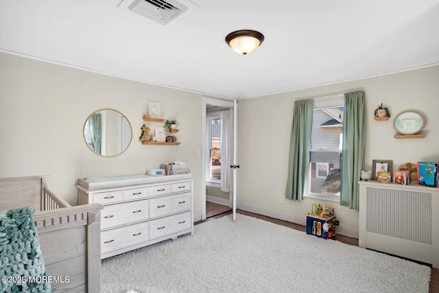 bedroom featuring radiator, visible vents, and baseboards