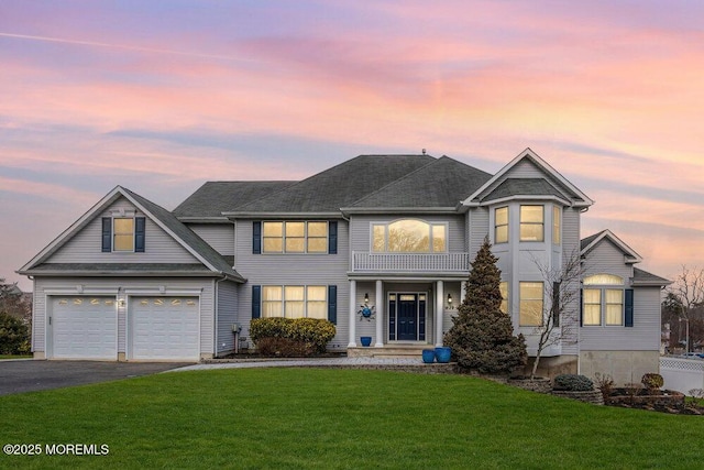 view of front of home with a front yard, an attached garage, and driveway