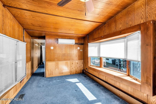 carpeted spare room featuring a ceiling fan, wooden ceiling, a wall mounted air conditioner, and wood walls