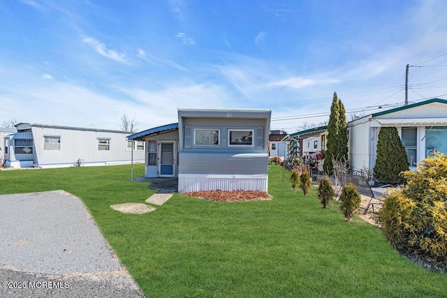 rear view of property featuring a yard