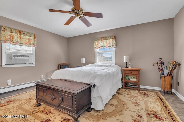 bedroom with ceiling fan, baseboards, light wood-type flooring, and a baseboard radiator