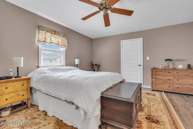 bedroom with light wood-style flooring and ceiling fan