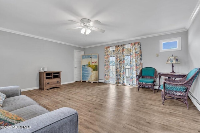 living area featuring plenty of natural light, crown molding, a ceiling fan, and wood finished floors