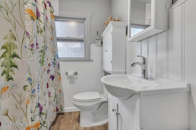 full bathroom featuring vanity, curtained shower, toilet, and wood finished floors