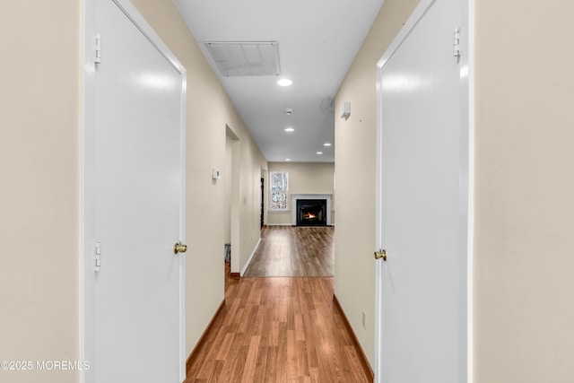 corridor with recessed lighting, light wood-style floors, visible vents, and baseboards