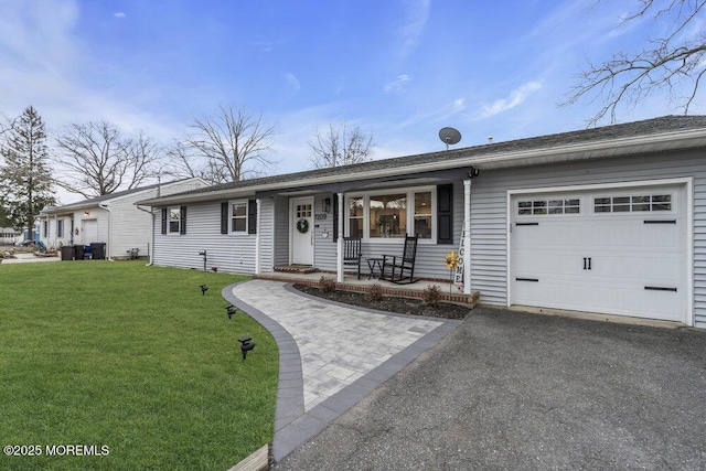 ranch-style house with a garage, a front yard, covered porch, and driveway