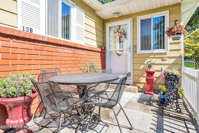 view of patio / terrace featuring outdoor dining space and fence