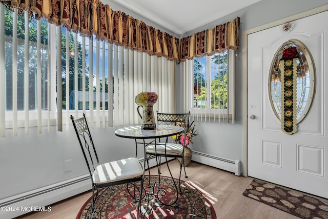 dining room with baseboard heating and wood finished floors