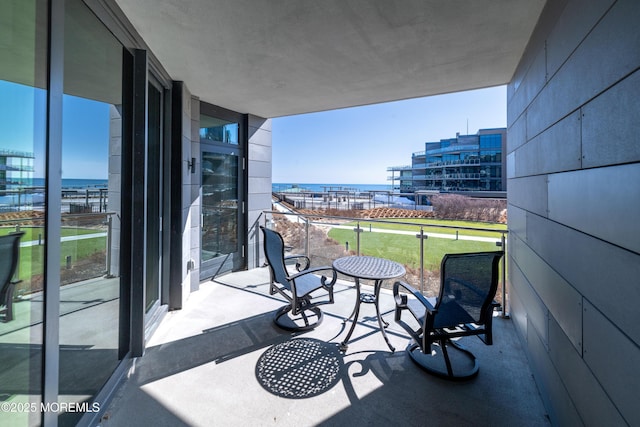 balcony featuring a view of city and a water view