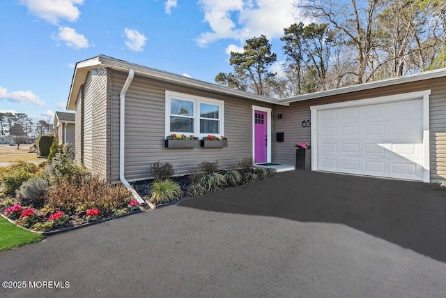 view of front of property with a garage and aphalt driveway