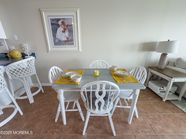 dining area with baseboards and tile patterned floors