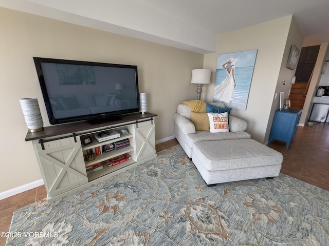 living area featuring tile patterned flooring and baseboards