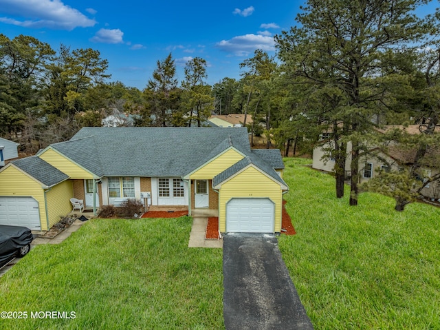 ranch-style house featuring a garage, aphalt driveway, a front yard, and a shingled roof