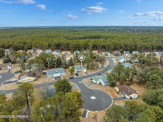 drone / aerial view with a residential view and a forest view