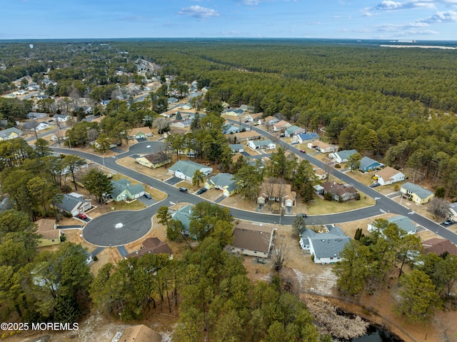 drone / aerial view with a residential view and a forest view