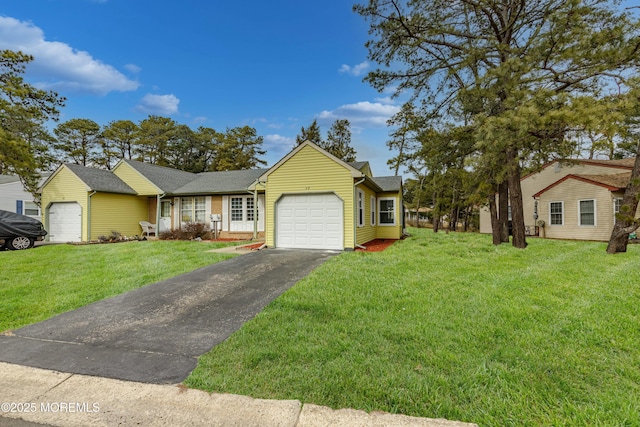 single story home featuring driveway, an attached garage, and a front yard