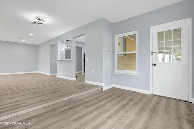 unfurnished room featuring light wood-type flooring, baseboards, and recessed lighting