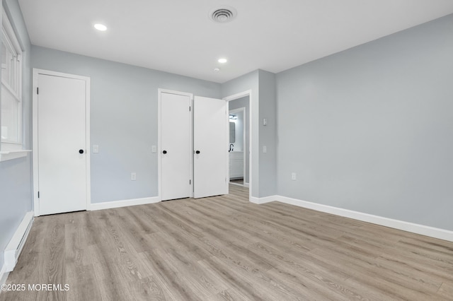 unfurnished bedroom featuring baseboards, recessed lighting, visible vents, and light wood-style floors