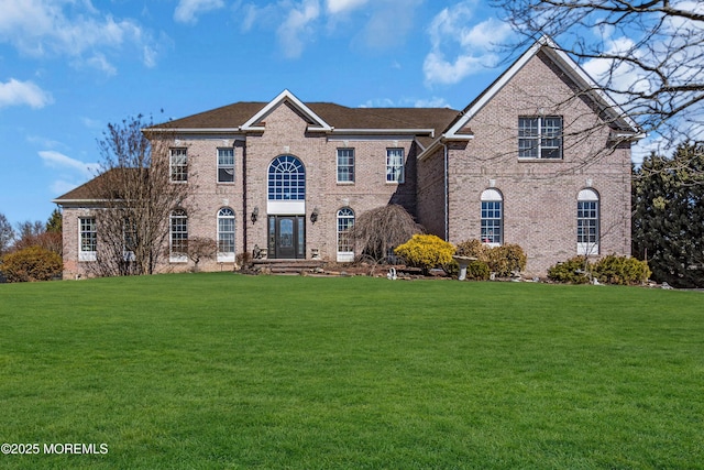 view of front of property with brick siding and a front lawn