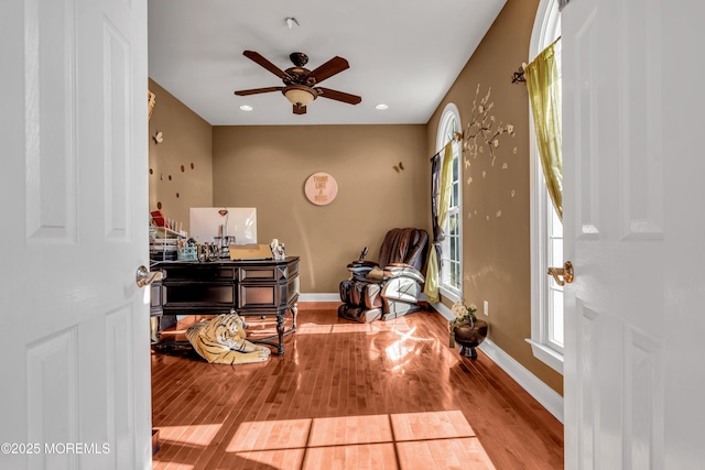 interior space with recessed lighting, ceiling fan, baseboards, and wood finished floors