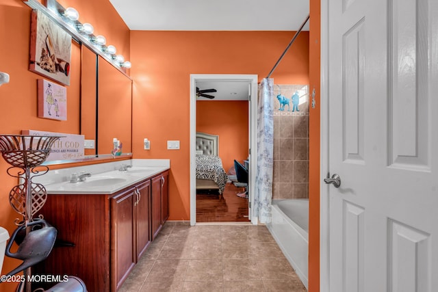 ensuite bathroom with double vanity, shower / tub combo, connected bathroom, a sink, and tile patterned flooring