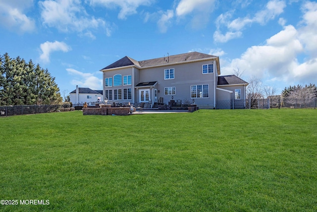 back of house featuring a patio area, a fenced backyard, and a lawn