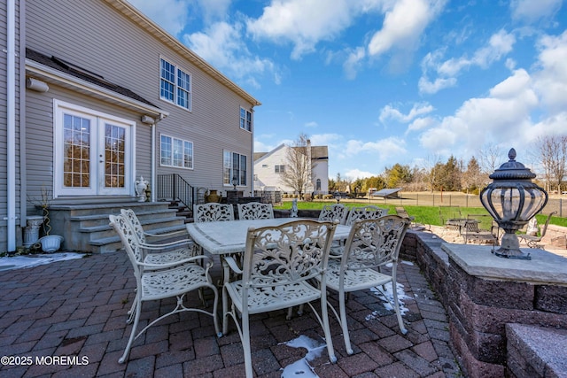 view of patio / terrace with entry steps, outdoor dining area, and fence