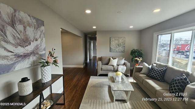 living area featuring baseboards, dark wood-style flooring, and recessed lighting