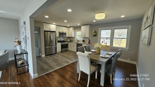 dining space with dark wood-style flooring, recessed lighting, visible vents, and baseboards